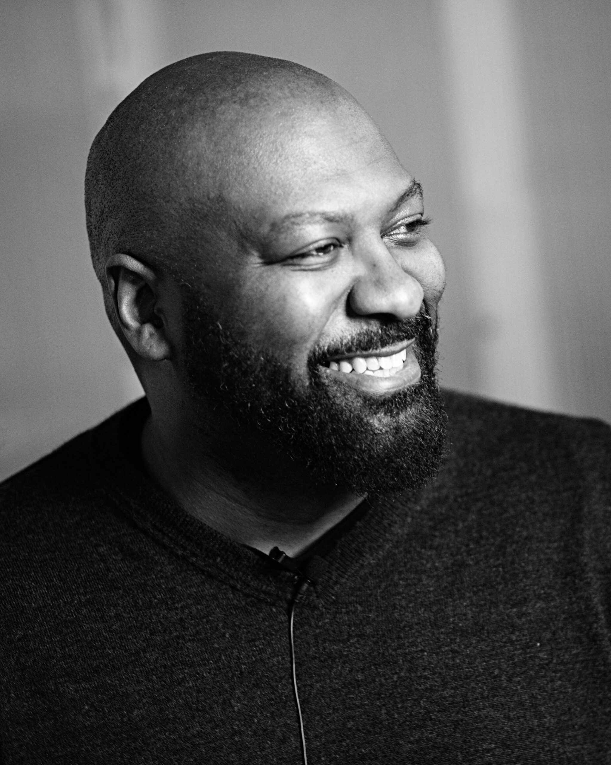 Black Men-014BW Smiling bald Black man with beard in black-and-white headshot by Varitay Studios, Racine WI